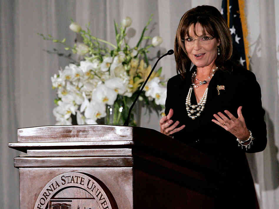 Sarah Palin gestures during her speech at a fundraising dinner.