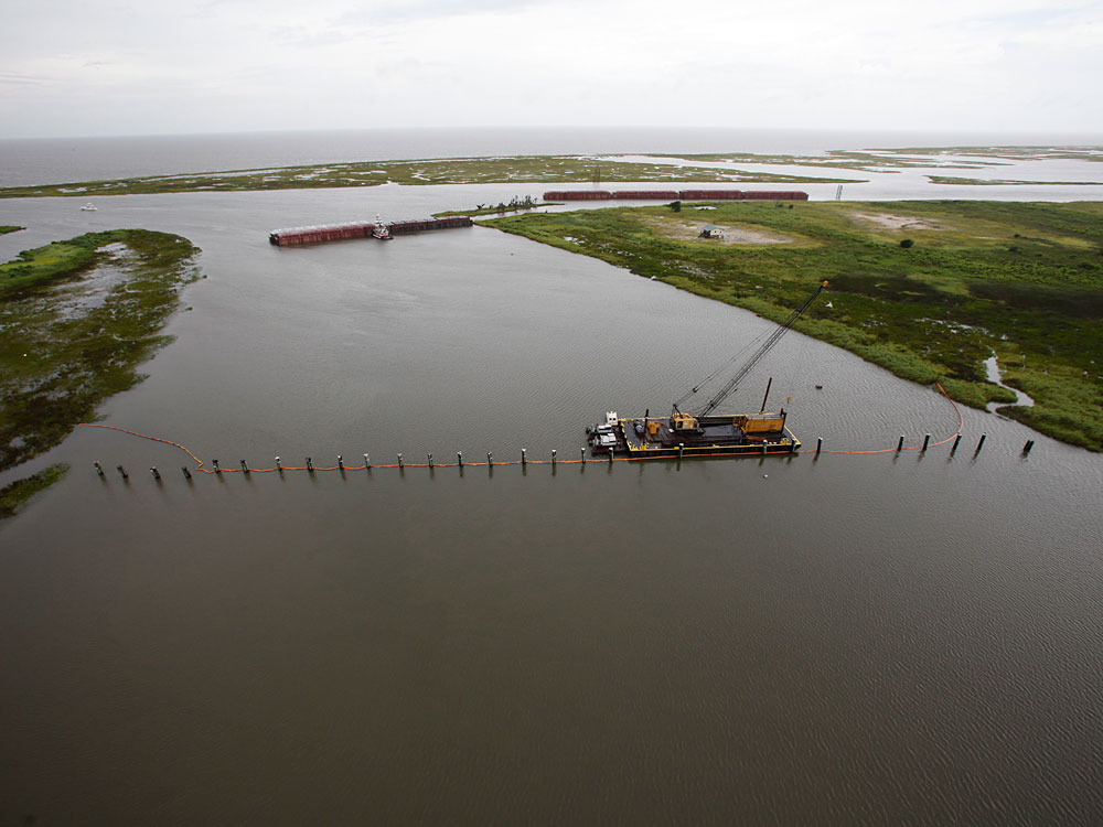 Barges lined up to block oil are seen from the air July 6 in The Rigolets