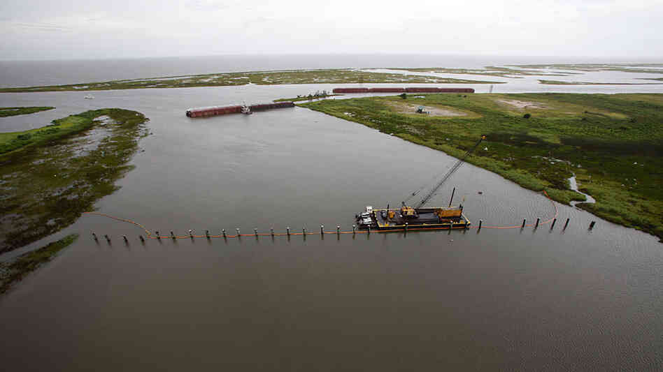 Barges lined up to block oil are seen from the air July 6 in The Rigolets