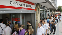 People stand in line outside a government job center in Madrid last month. After Spain adopted the euro in 1999, investment flowed into the country and the economy boomed. Now, it is suffering from the highest unemployment rate in the 16-nation eurozone and grappling with the way to recovery.