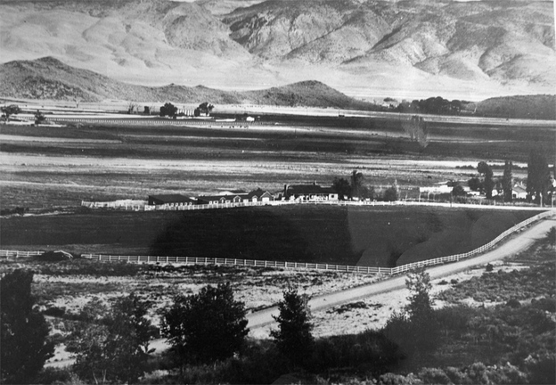 A wide view of the mountainous valley occupied by view of the Whitney Ranch (center).