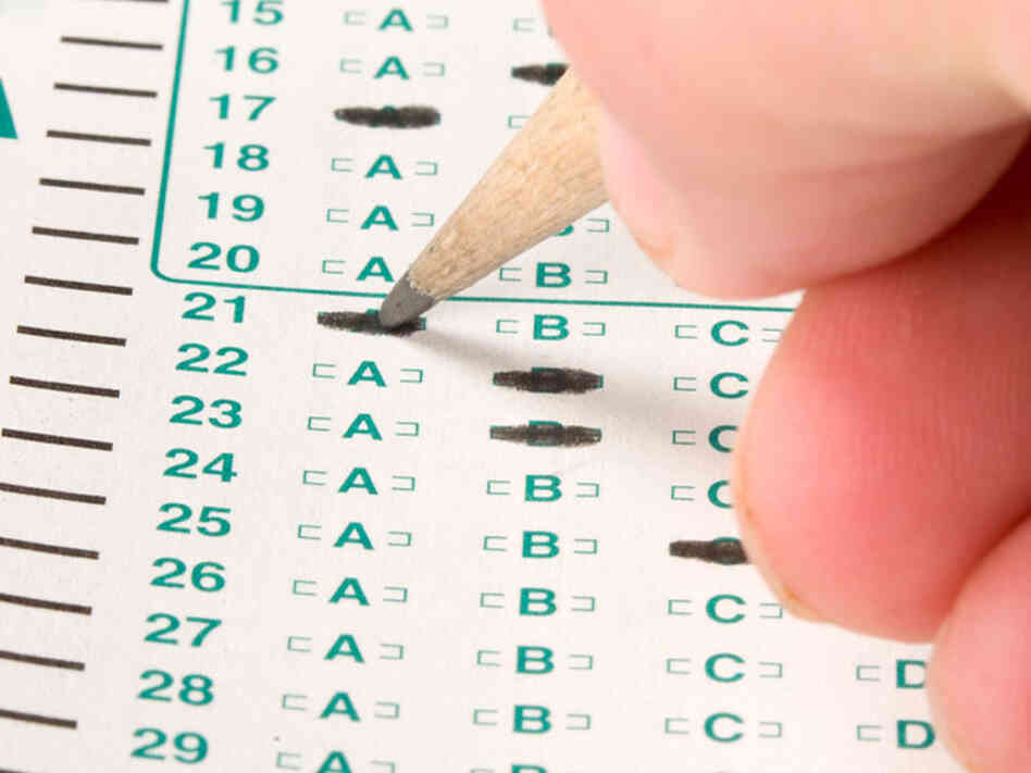 A test-taker uses a pencil to fill in answers