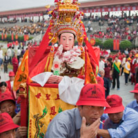 A village Mazu statue is carried into Meizhou Island's main square