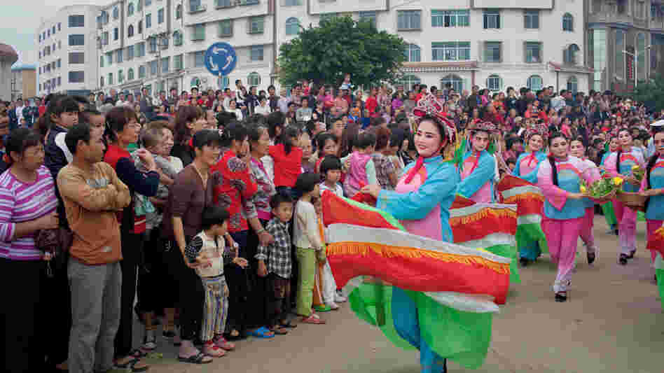 Dancers in boat costumes whirl as part of the parade celebrating Mazu on Meizhou Island Dancers in boat costumes whirl as part of the parade celebrating Mazu on Meizhou Island