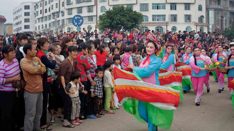 Dancers in boat costumes whirl as part of the parade celebrating Mazu on Meizhou Island Dancers in boat costumes whirl as part of the parade celebrating Mazu on Meizhou Island