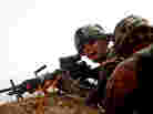 A soldier with Bravo Company, 101st Airborne Div., yells for more ammunition 