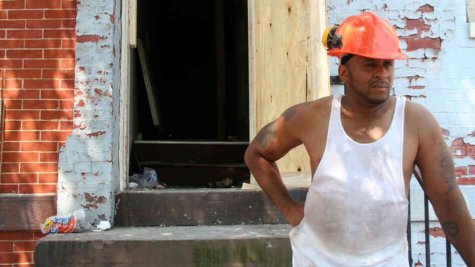 Neil Joseph outside a row house in Baltimore that he's rehabbing. Neil Joseph outside a row house in Baltimore that he's rehabbing.