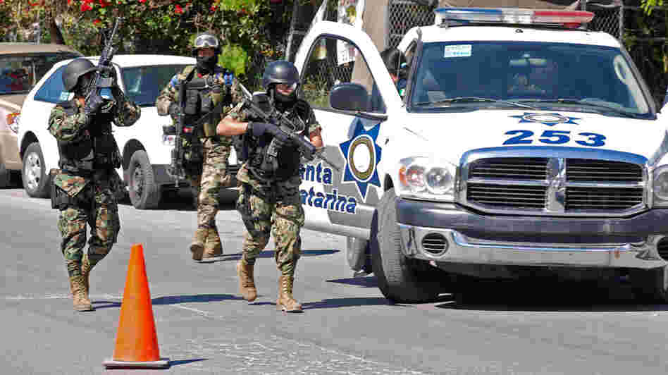 Mexican marines patrol at a crime scene near Monterrey