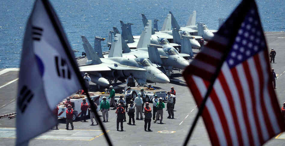 Crew members stand on the flight deck of the USS George Washington for joint military exercises. Crew members stand on the flight deck of the USS George Washington for joint military exercises.