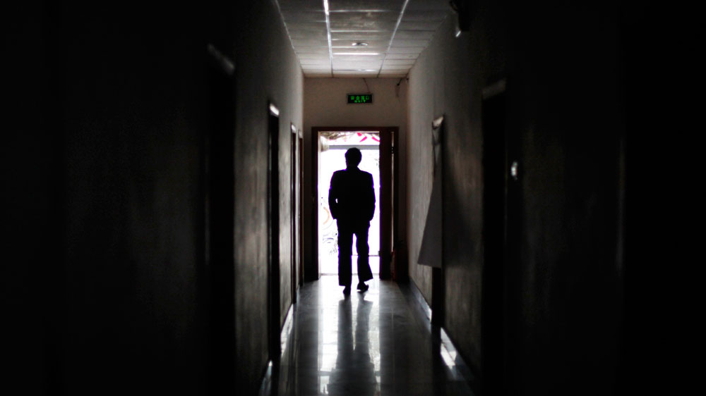 A man walks through a Beijing building formerly used as a secret detention center in 2009. In these 