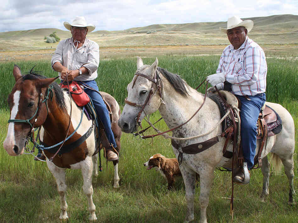 Henry Real Bird (left) and his riding partner Levi Bruce on horseback in Montana.