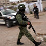Military police stand guard at the scene of a murder in Juarez, Mexico in March.