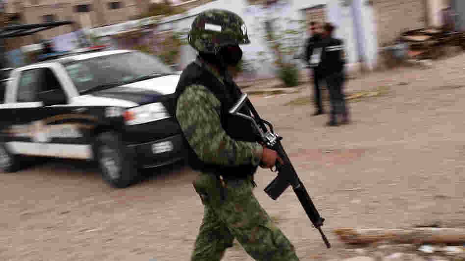 Military police stand guard at the scene of a murder in Juarez, Mexico in March.