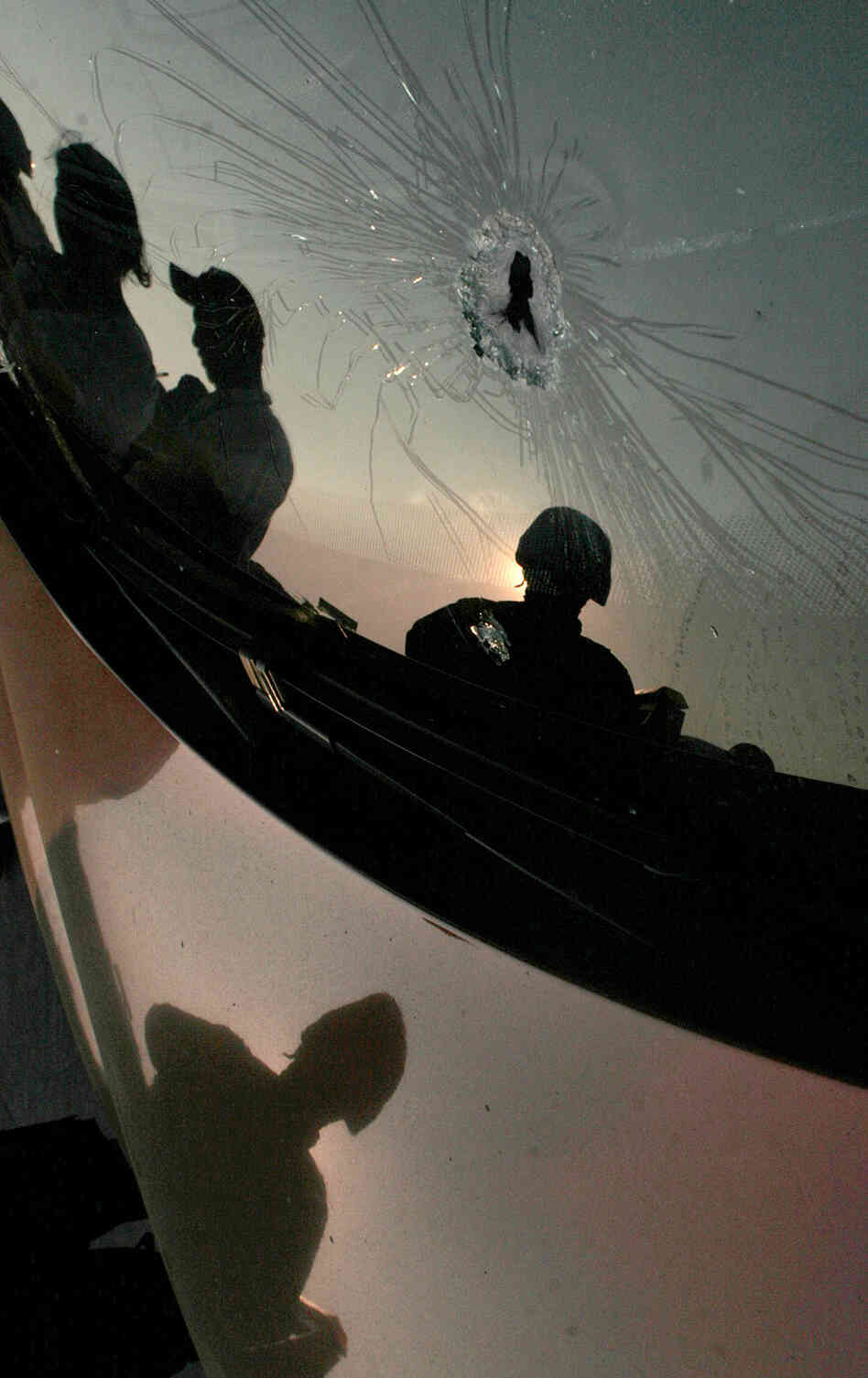 A bullet-riddled car following a shooting A bullet-riddled car following a shooting