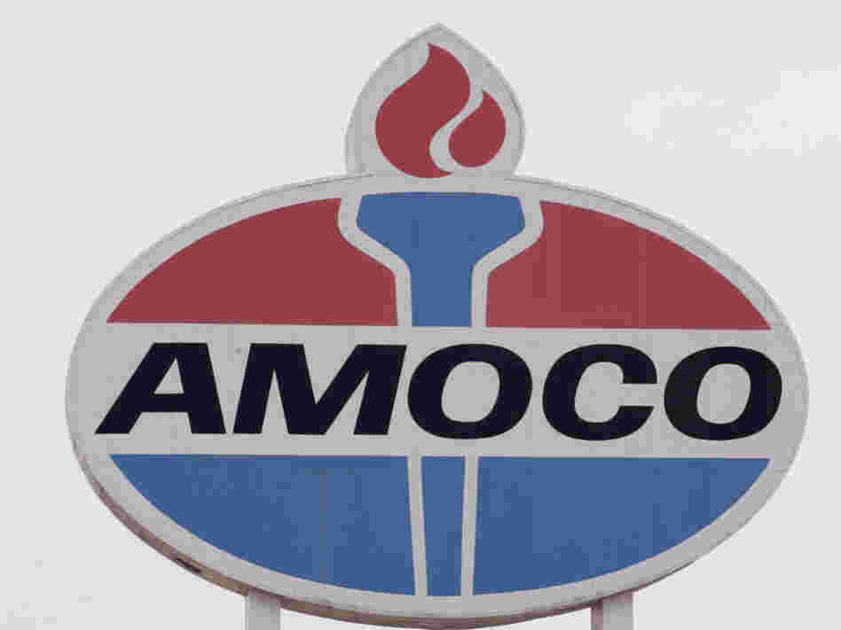 An Amoco sign stands above a gas station in 2005.