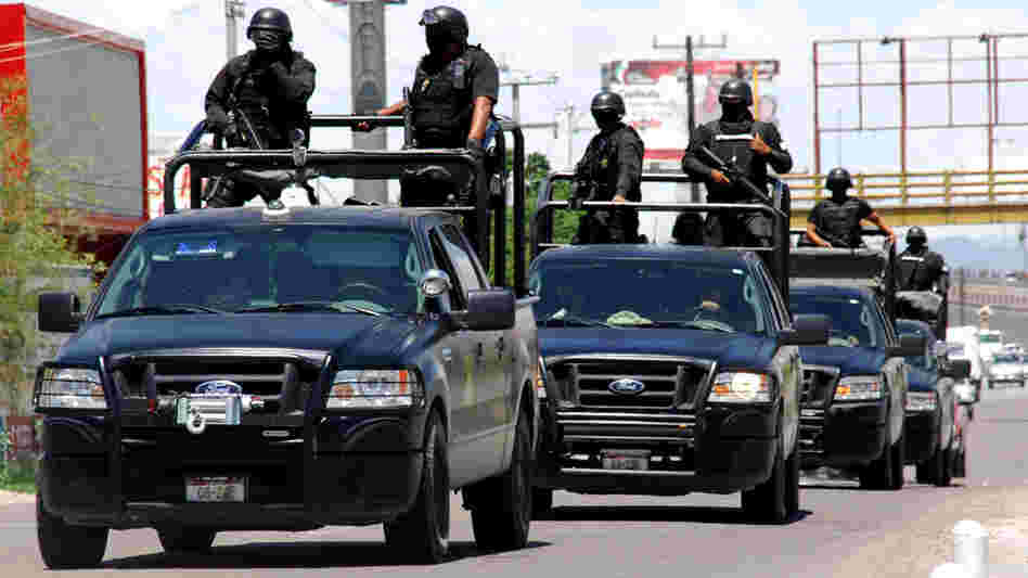 Police officers patrol a street in Torreon