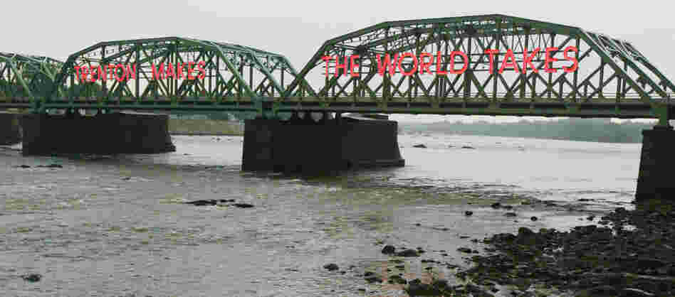 The Lower Trenton Bridge over the Delaware River reads 'Trehton Makes. The World Takes." The Lower Trenton Bridge over the Delaware River reads 'Trehton Makes. The World Takes."