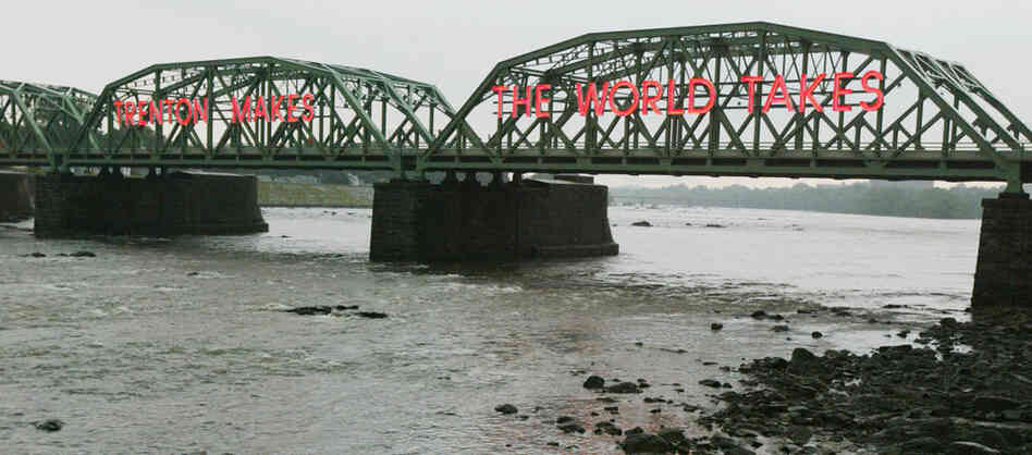 The Lower Trenton Bridge over the Delaware River reads 'Trehton Makes. The World Takes." The Lower Trenton Bridge over the Delaware River reads 'Trehton Makes. The World Takes."