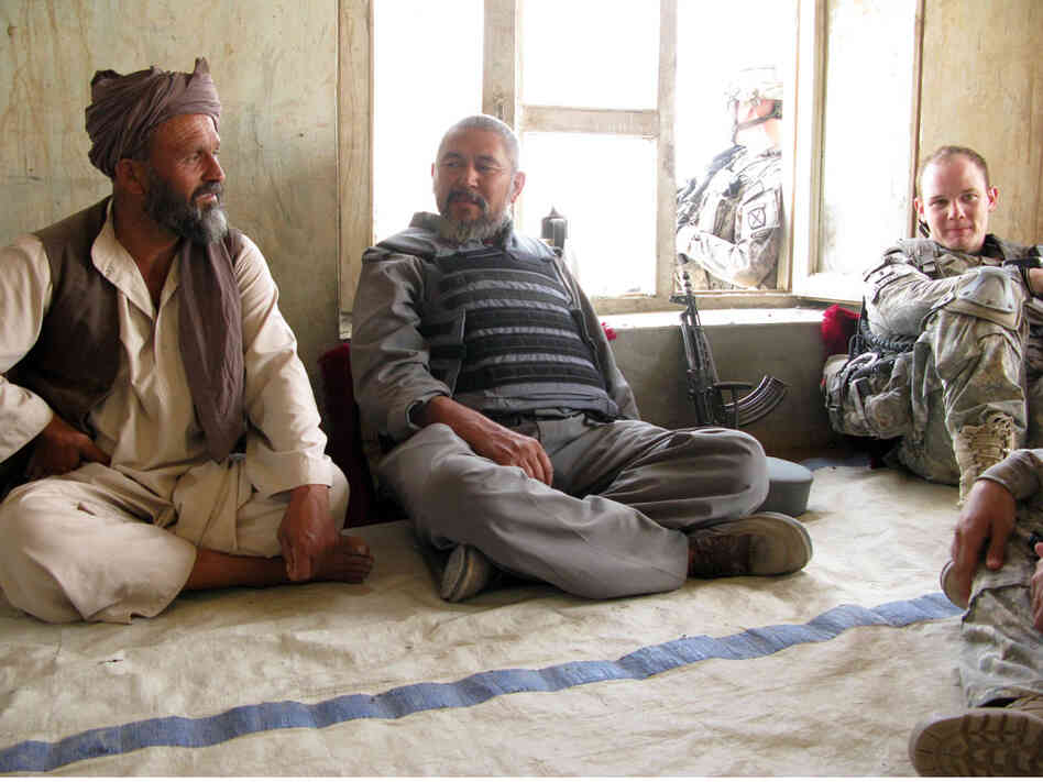 U.S. Army Lt. Mike Kehoe sits down for a chat with a village elder and the local police chief.