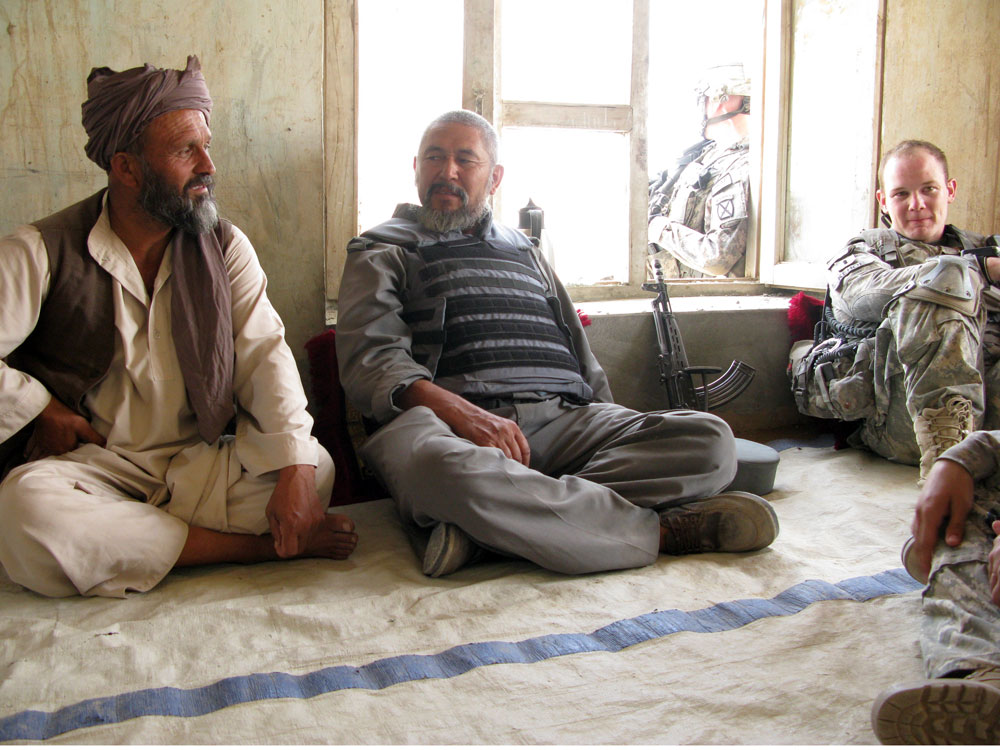 U.S. Army Lt. Mike Kehoe sits down for a chat with a village elder and the local police chief.