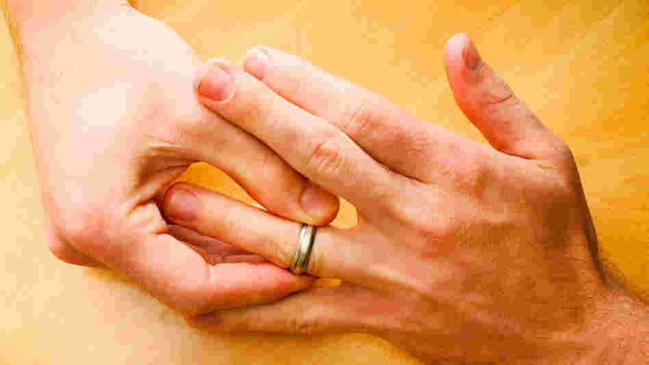 Man tugs at wedding band
