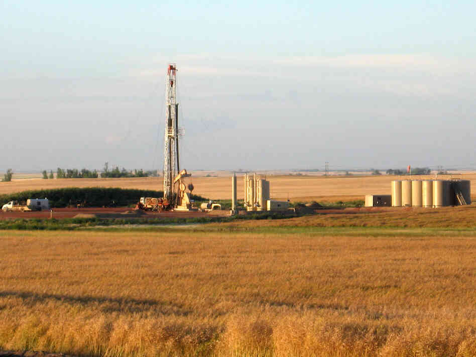 An oil drilling rig stands amid a  farmer's field near Stanley, N.D.