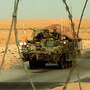 A column of Stryker armored vehicles carrying Army troops crosses the border from Iraq into Kuwait. A column of Stryker armored vehicles carrying Army troops crosses the border from Iraq into Kuwait.