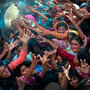 Villagers, displaced from their homes by flooding, fight for bags of flour. Villagers, displaced from their homes by flooding, fight for bags of flour.