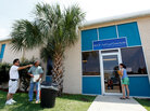 Local residents stand outside the new Gulf Coast Claims Facility in New Orleans Local residents stand outside the new Gulf Coast Claims Facility in New Orleans