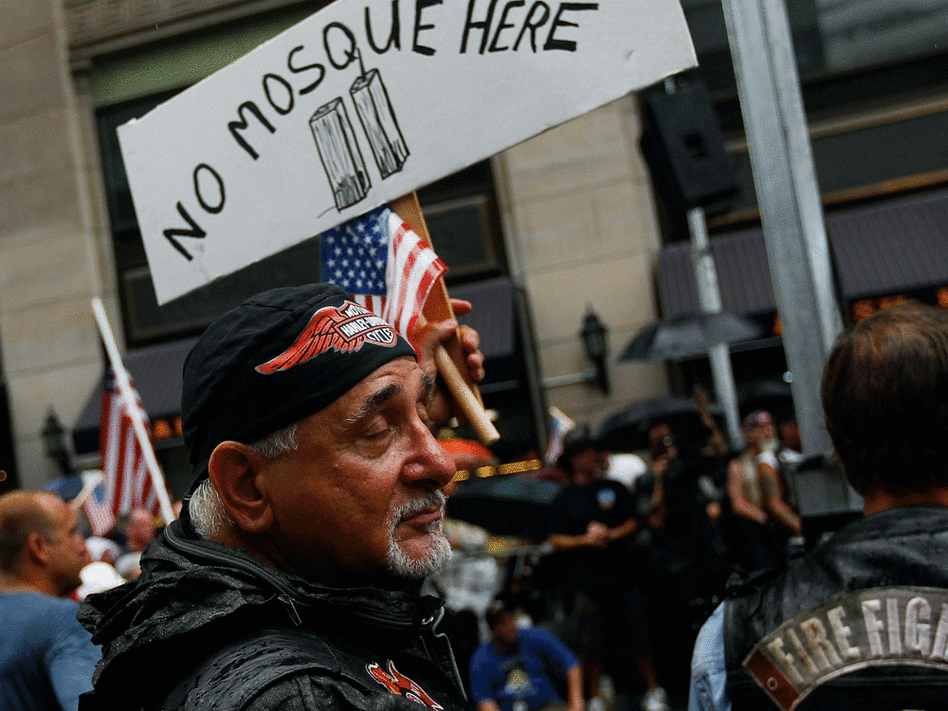 An opponent of a planned Islamic cultural center near ground zero holds a sign during a protest.