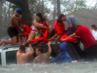 Volunteers rescue a family following Hurricane Katrina. Volunteers rescue a family following Hurricane Katrina.