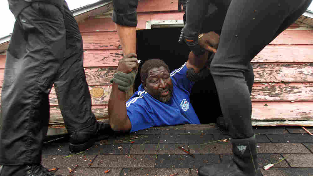 A man is rescued from his roof in New Orleans after Hurricane Katrina. A man is rescued from his roof in New Orleans after Hurricane Katrina.