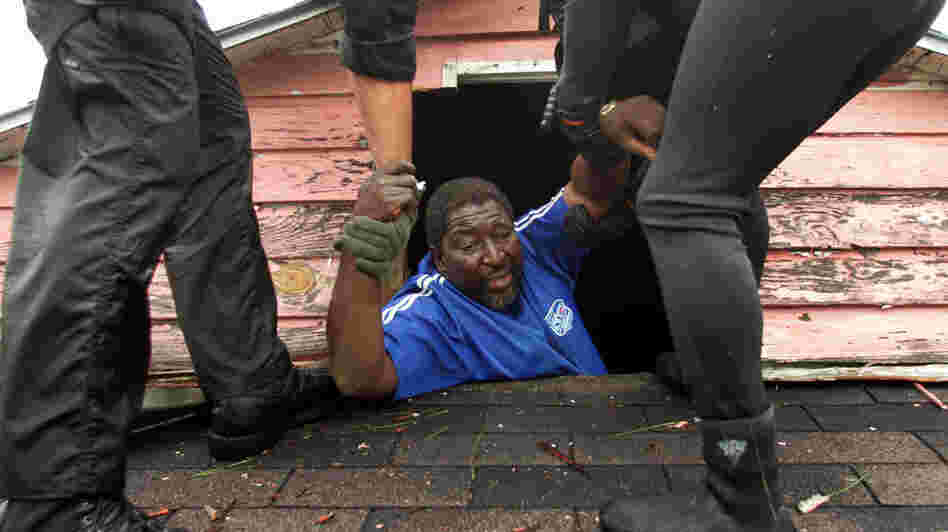 A man is rescued from his roof in New Orleans after Hurricane Katrina. A man is rescued from his roof in New Orleans after Hurricane Katrina.