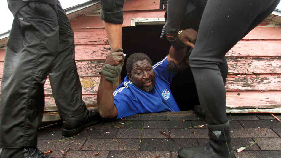 A man is rescued from his roof in New Orleans after Hurricane Katrina. A man is rescued from his roof in New Orleans after Hurricane Katrina.