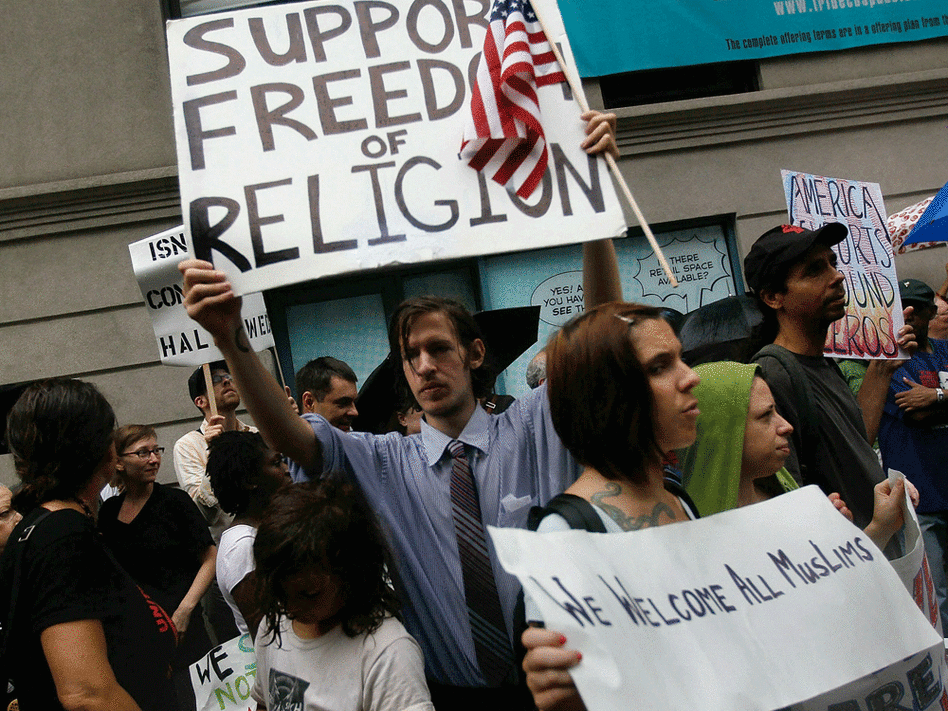 Supporters of the center chant slogans and carry signs during the Sunday demonstration.