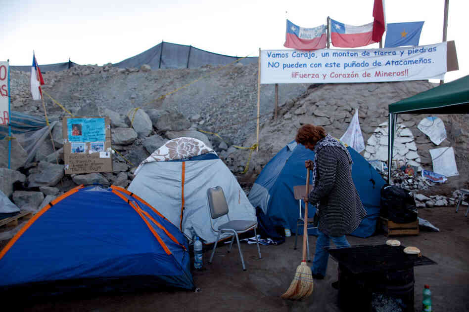 Lilian Ramirez sweeps outside a tent set up near the collapsed mine Lilian Ramirez sweeps outside a tent set up near the collapsed mine