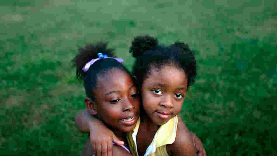 Two girls are seen at a housing project in New Orleans in 2007.