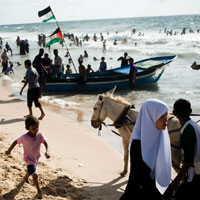 Palestinians enjoy the Mediterranean Sea at a Hamas-run beach club in Gaza City