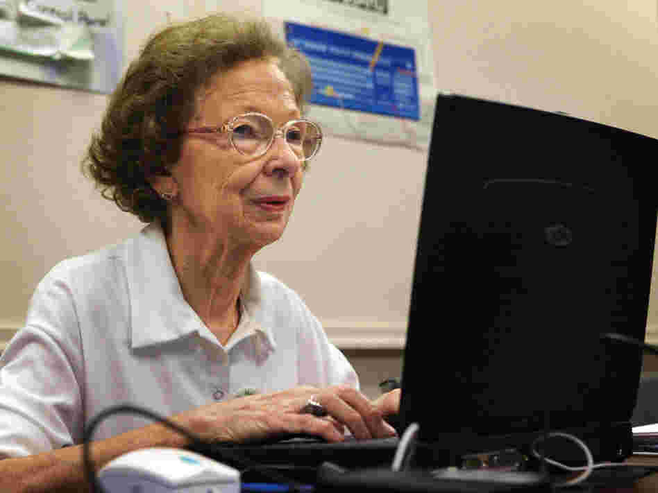 77-year-old Suzette D'Hooghe works on her laptop computer.