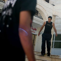 Young Palestinian men practice parkour
