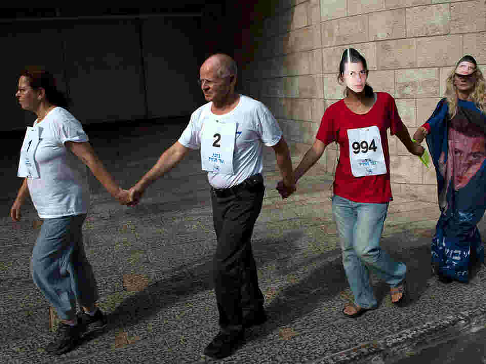 Aviva, left, and Noam Shalit, second left, protest their son's captivity