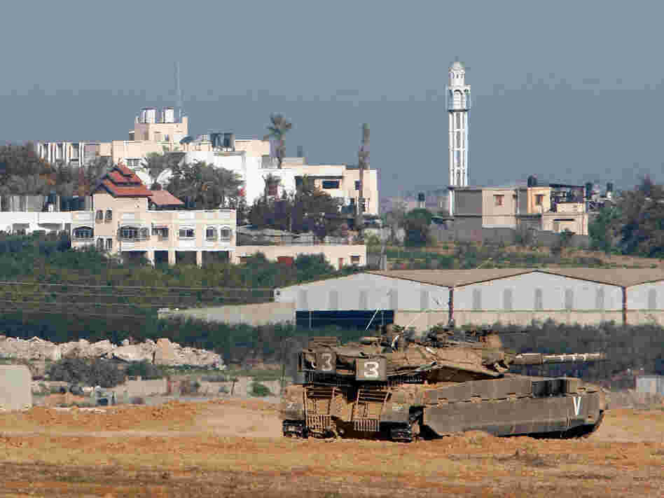 An Israeli tank monitors the border with the Gaza Strip near Kibbutz Nahal Oz