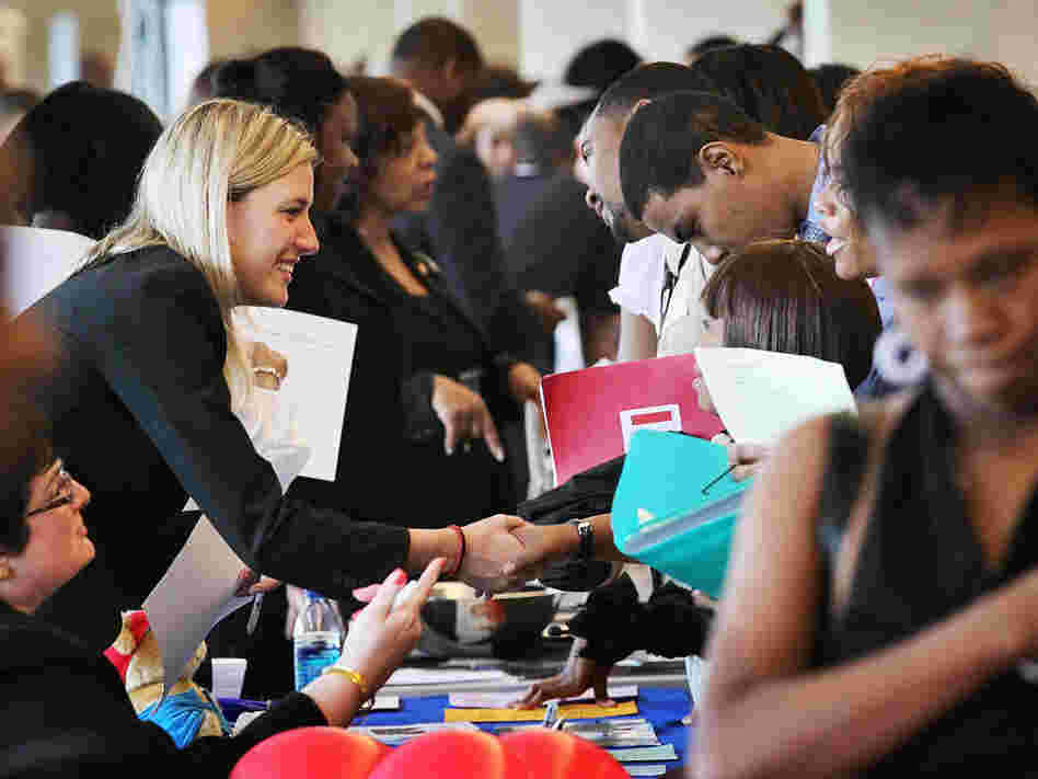 Job seekers speak with recruiters during a career fair  in Chicago.
