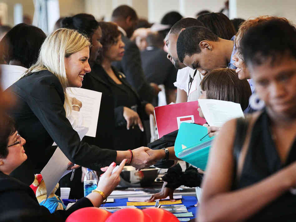 Job seekers speak with recruiters during a career fair  in Chicago.
