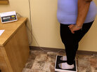 Overweight teen on scale. Overweight teen on scale.