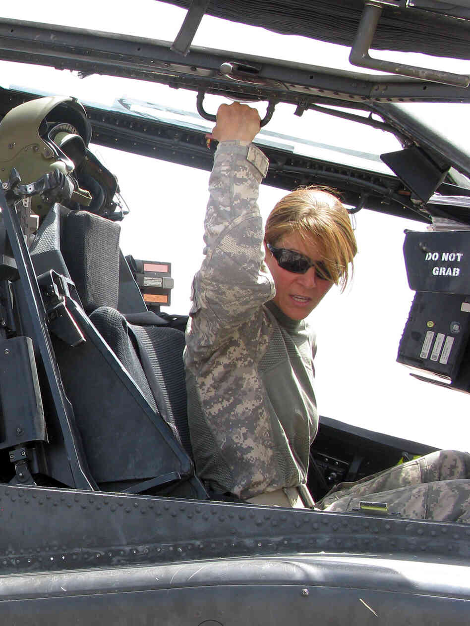 U.S. Army Capt. Nicole Jordan sits in the cockpit of an Apache attack helicopter
