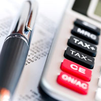 Income tax return with pen and calculator