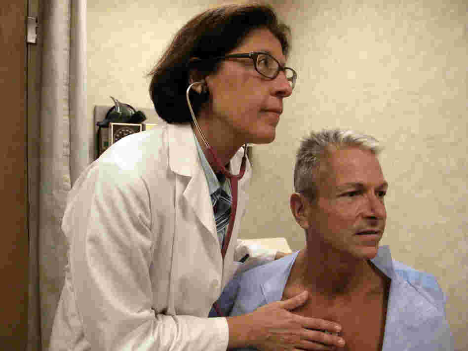 Internist Nesli Basgoz exams patient Barry Arcangeli who has a leaky heart valve.