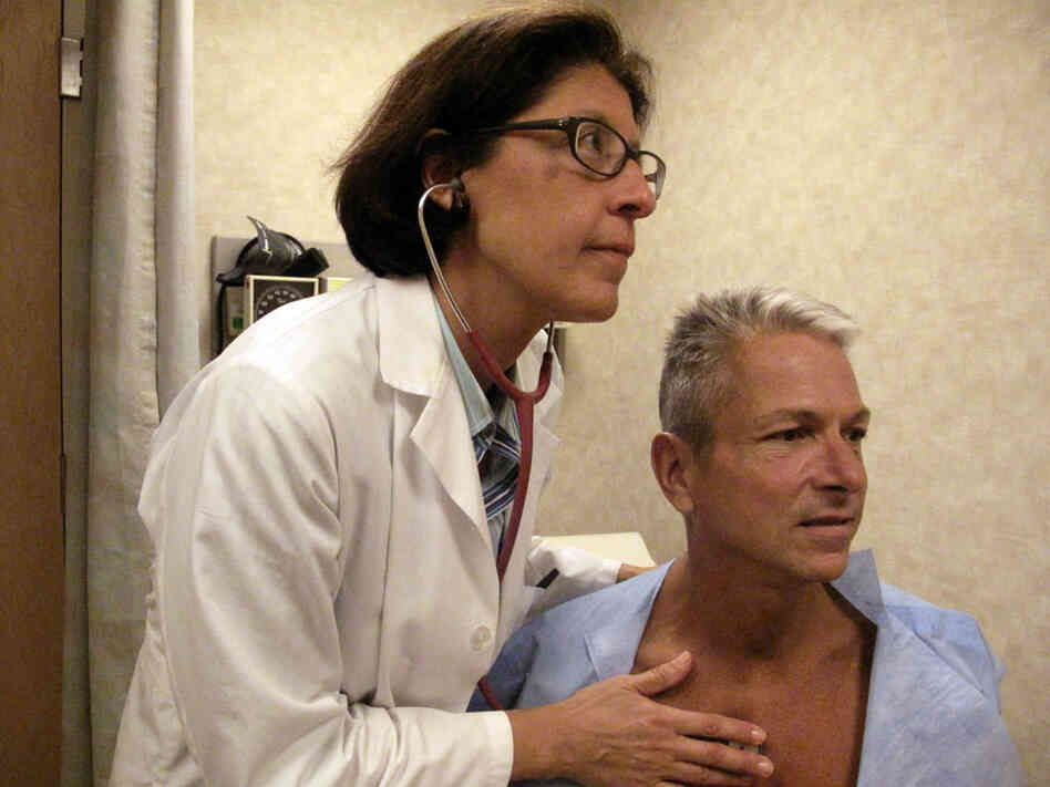 Internist Nesli Basgoz exams patient Barry Arcangeli who has a leaky heart valve.