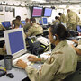 Soldiers monitor computer screens inside the U.S. Central Command's mobile headquarters. Soldiers monitor computer screens inside the U.S. Central Command's mobile headquarters.